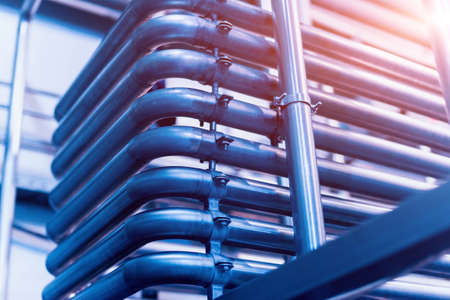 Modern interior of a brewery. Barrels and pipes. Factory interior. Industry backgroundの写真素材