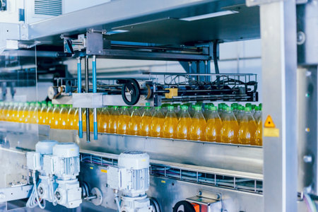 Beverage factory interior. Conveyor with bottles for juice or water. Modern equipments