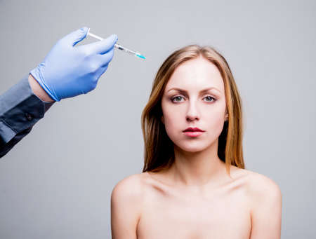 Beautician and the patient in the clinic of aesthetic medicine.の写真素材