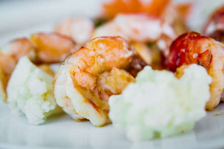 Fried shrimps on a plate with vegetables and sauces.の写真素材