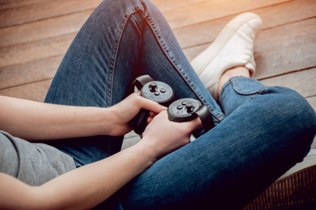 The beautiful girl playing games with virtual reality goggles
