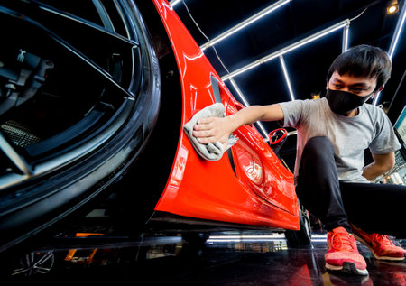 Car service worker polishing car with microfiber cloth. Tools for polishing