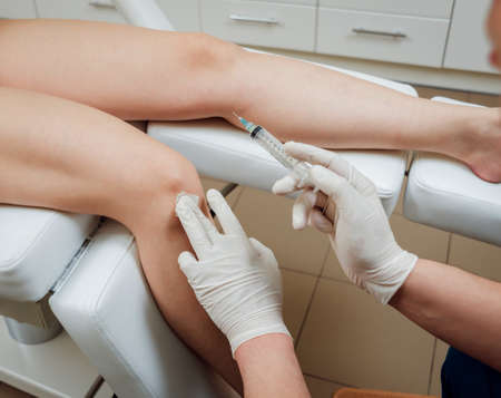 Platelet-rich plasma injection of the knee. Backgroundの写真素材