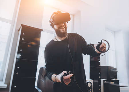 The young man plays a game at the office.の写真素材