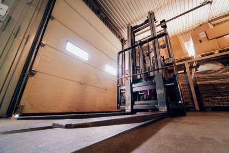 Forklift loader. Pallet stacker truck equipment at warehouseの写真素材