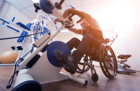 Disabled man training in the gym. Rehabilitation center