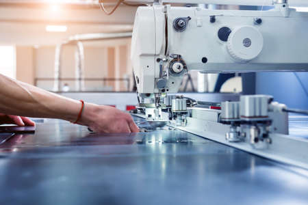 Fabric industry production line. Textile factory. Working tailoring processの写真素材