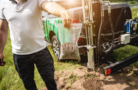 Soil examination. Collecting black soil on the field for examination