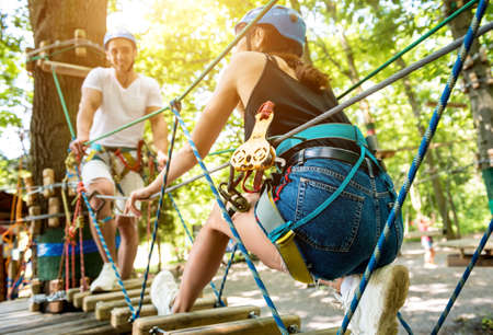 Young couple having fun time in adventure rope park.の写真素材