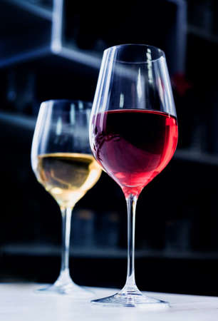 Red wine in a glass at restaurant. Light background.の写真素材