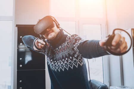 The young man plays a game at the office.の写真素材