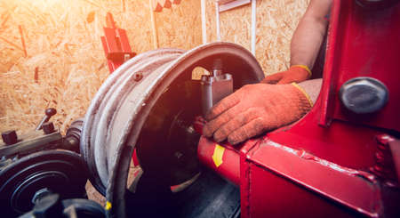 Professional car mechanic replace tire on wheel. Cleaning discの写真素材