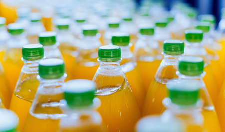 Conveyor with bottles for juice or water. Beverages factory equipmentsの写真素材