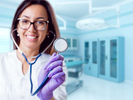 Experienced doctor in operating room. Light background.の写真素材