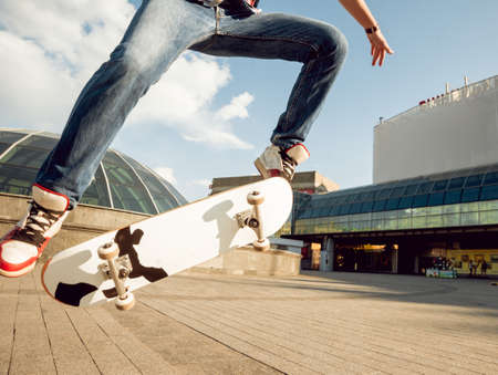 Young man riding a skateboard. Town Square.の写真素材