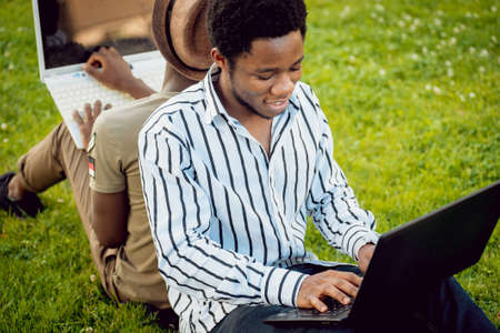 African students in the park. Beautiful backgroundの写真素材