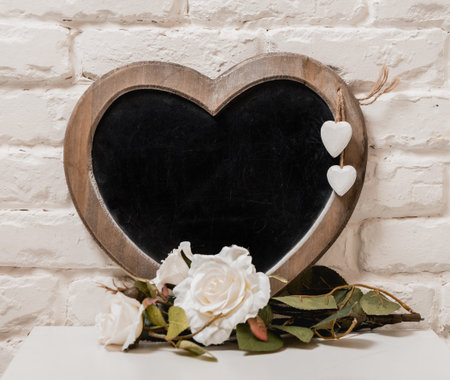 The frame as a heart with flowers on the wall.