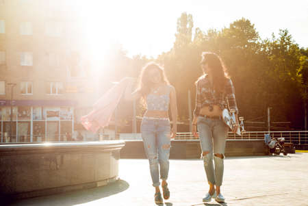 Young girls with skateboard. In the park.の写真素材