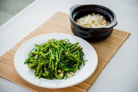 Boiled greens with rice on the white plate.