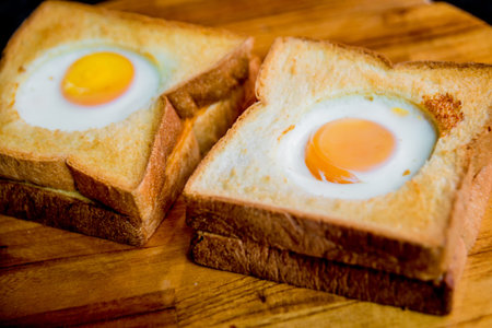 Toast bread with egg inside on the board