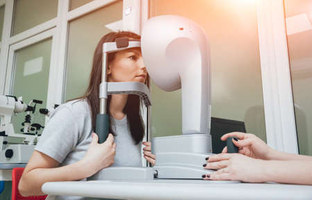 Optometrist is doing corneal topography. Corneal exam. Ophthalmology clinicの写真素材
