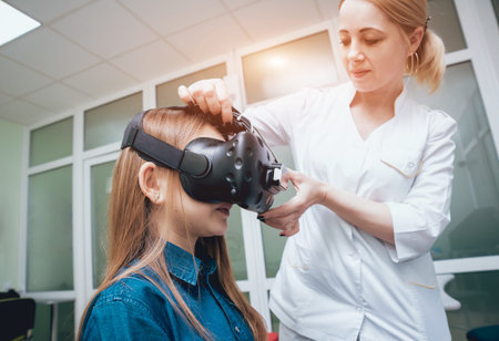Ophthalmology doctor checks the girls vision with virtual reality goggles.
