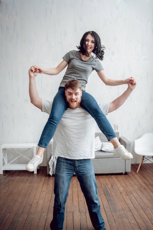 Happy couple having fun and laughing at home.