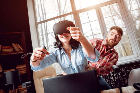 The young man with girlfriend plays a game at the office.の写真素材