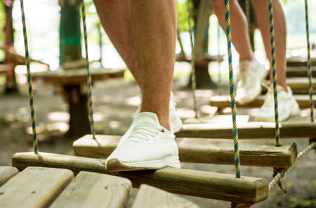 Young couple having fun time in adventure rope park.の写真素材