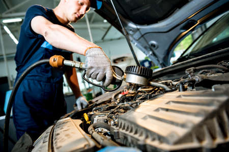 Car mechanic change engine oil. Car repair. Service stationの写真素材