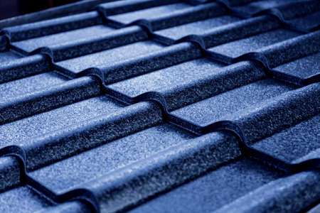 Blue metallic roof tiles background with drops of water.の写真素材
