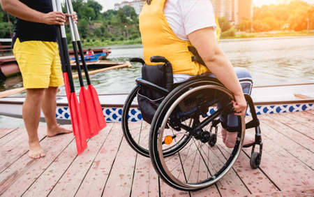 People with disabilities in life vests on the pier.の写真素材