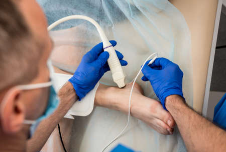 Cardiologist use tubes and ultrasound for radiofrequency catheter ablation.の写真素材