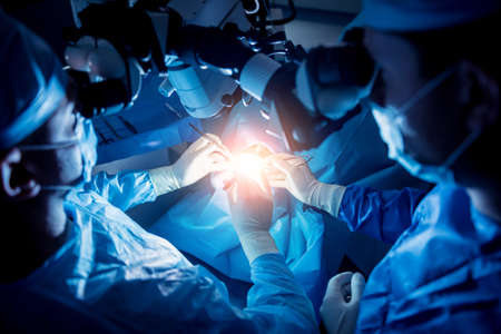 A team of surgeons performing brain surgery to remove a tumor.の写真素材
