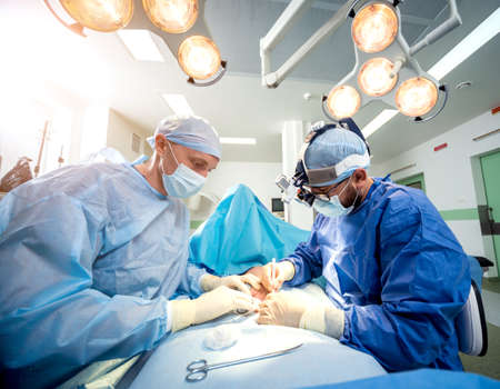 Surgeons in the operating room trying to save the patients hand.の写真素材