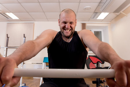 Disabled man training in the gym. Rehabilitation center