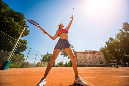 Young athletic woman playing tennis on the court.の写真素材