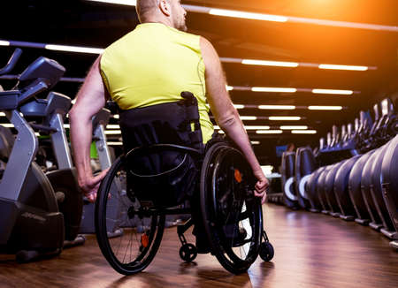 Disabled man training in the gym of rehabilitation centerの写真素材