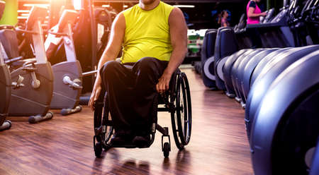 Disabled man training in the gym of rehabilitation centerの写真素材