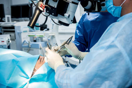 A team of surgeons performing brain surgery to remove a tumor.の写真素材