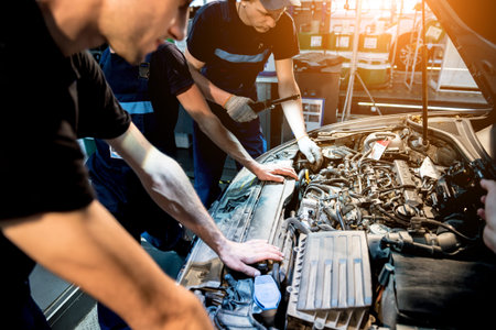 Car mechanic repair engine at service station. Car repair