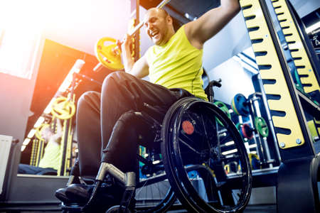 Disabled man training in the gym of rehabilitation centerの写真素材