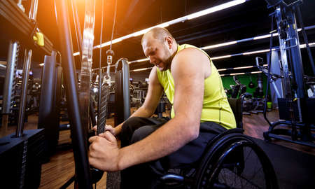 Disabled man training in the gym of rehabilitation centerの写真素材