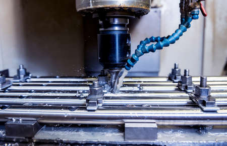 CNC milling machine drills holes in the pipe.の写真素材