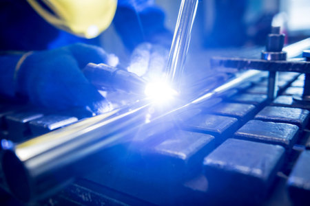 Welder working in a steel factory with argon welding