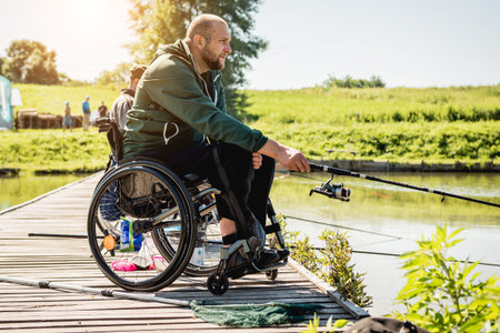 Young disabled man in a wheelchair fishing.