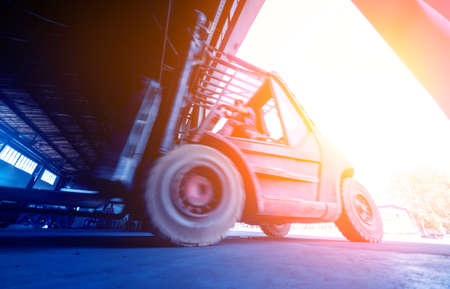 The big industrial forklift drives into the warehouse.の写真素材