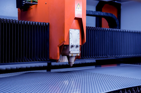 The laser cutting machine cutting the sheet of metal