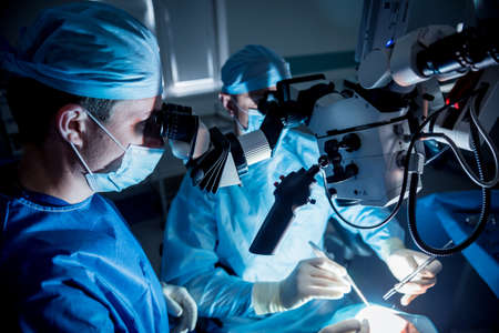 A team of surgeons performing brain surgery to remove a tumor.の写真素材