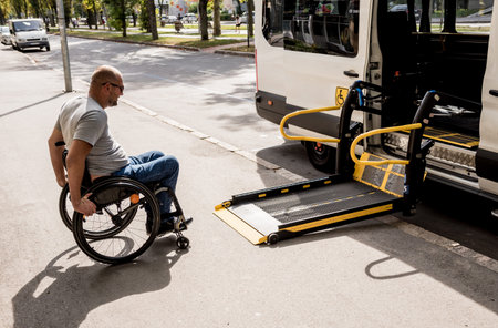 A man in a wheelchair moves to the lift of a specialized vehicle